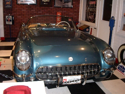 [Image of the front end of a blue convertible corvette.]