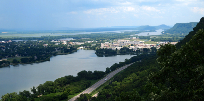 [Same scene as other photo but from a slightly lower level. The dark rain cloud is now at the left edge of the scene and the river valley is bathed in sunlight.]