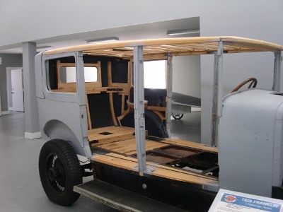 [Car with most of wood frame visible. It has no doors.]